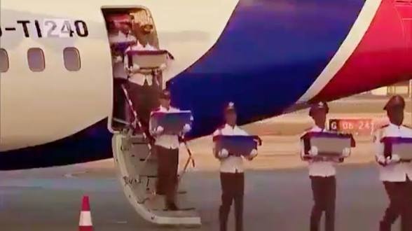 Ashes of dead bodies being removed from an airplane